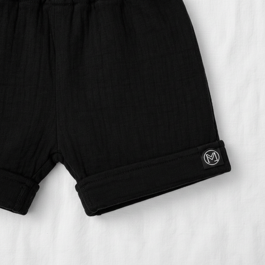 ECLIPSE baby shorts detail — elasticated waistband and cuffed hem, monochrome black cotton