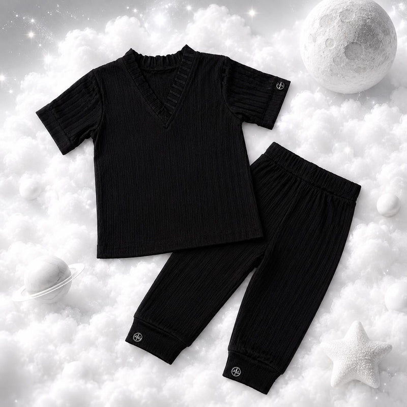 ECLIPSE baby lounge PJ set — top and pants together, flat lay, monochrome black
