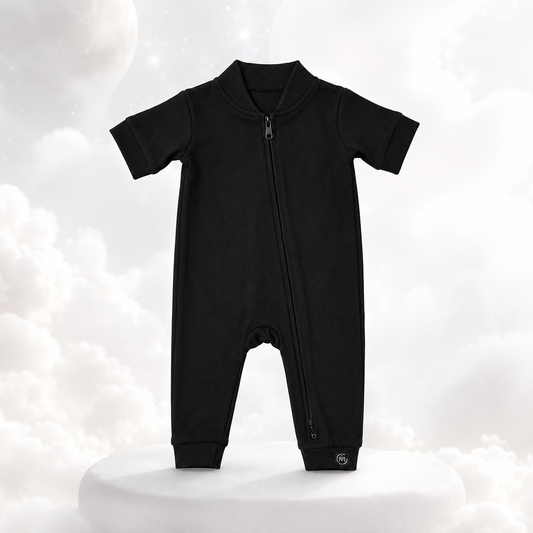 ECLIPSE short sleeved baby romper in black — full-length zip, ribbed ankle cuffs, flat lay
