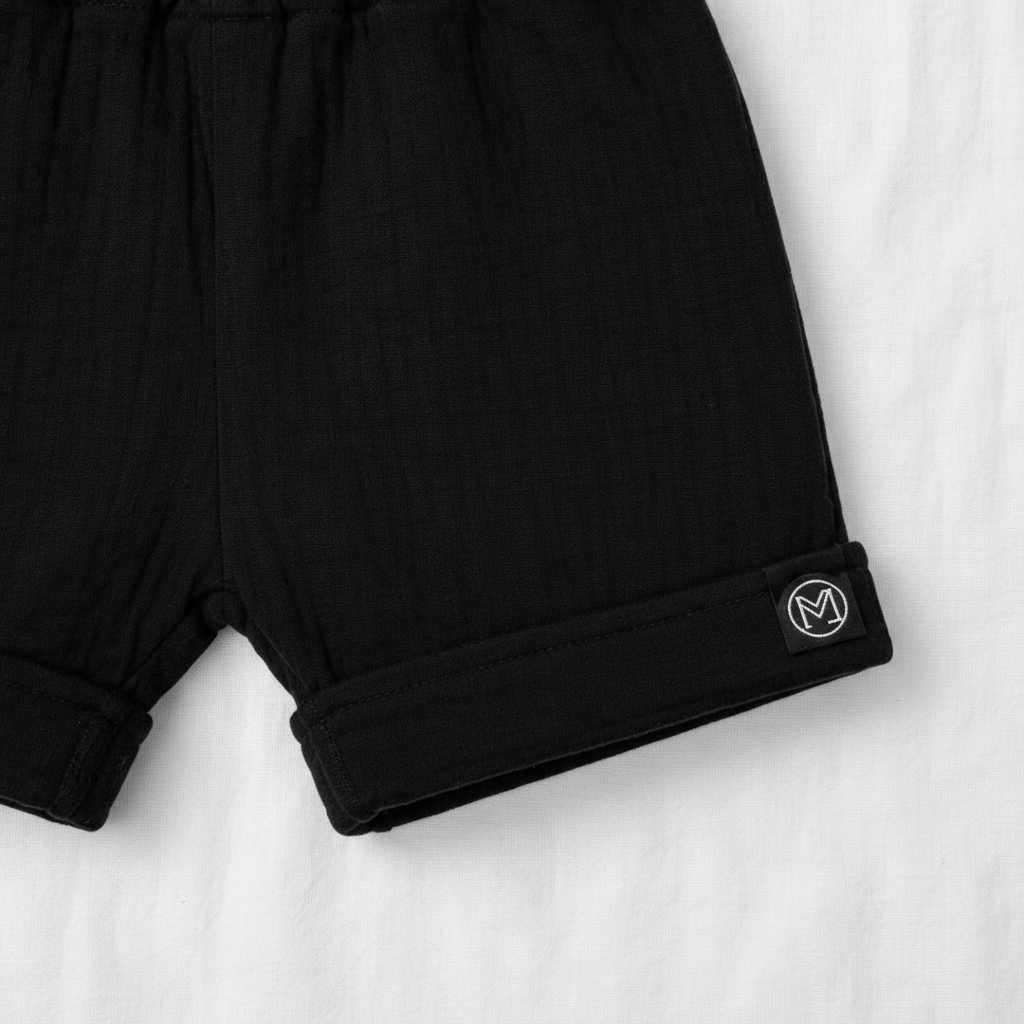 ECLIPSE baby shorts detail — elasticated waistband and cuffed hem, monochrome black cotton